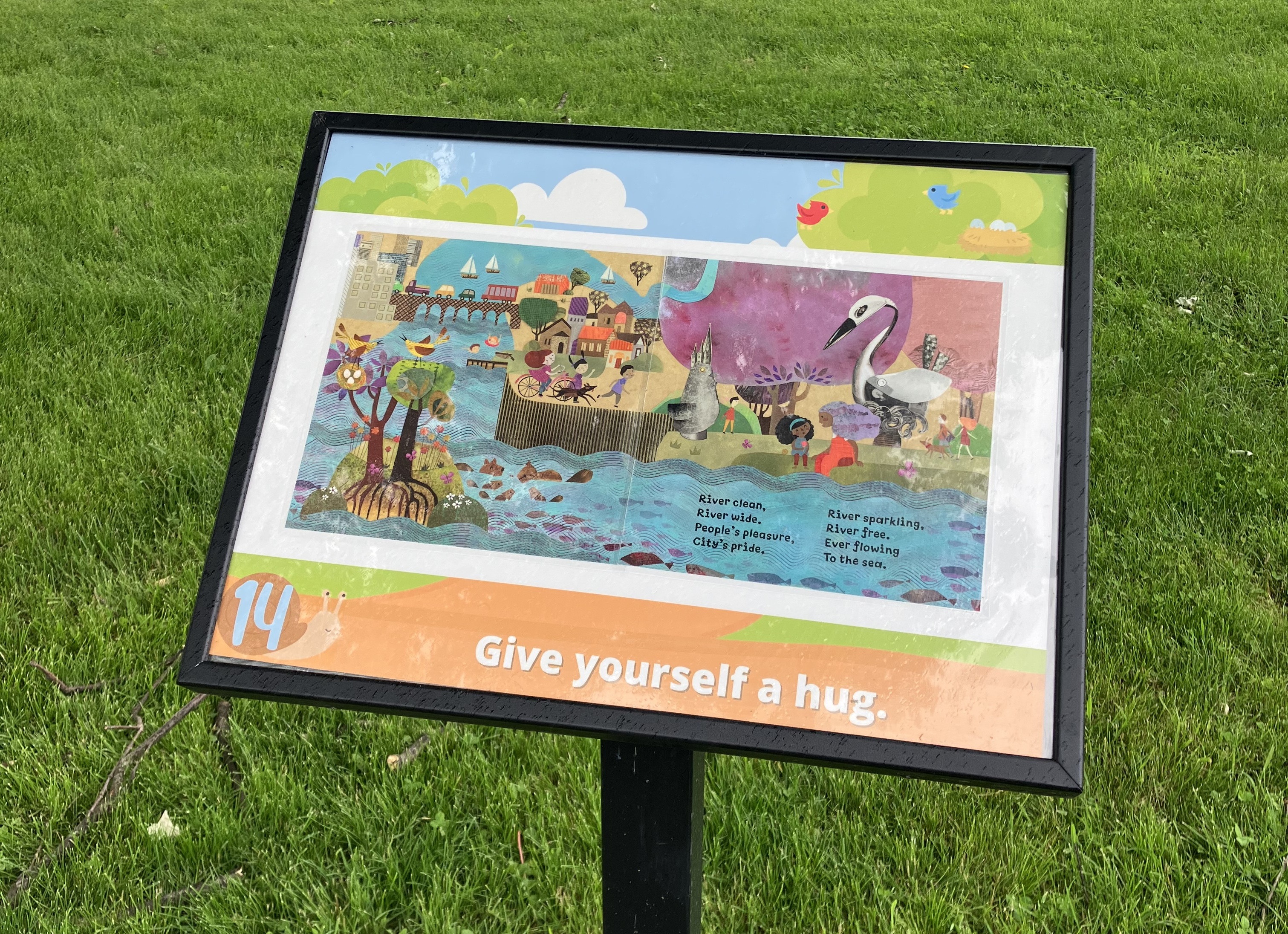Story Trail sign 14 with the two pages from the picture book "Scrap Metal Swan".
