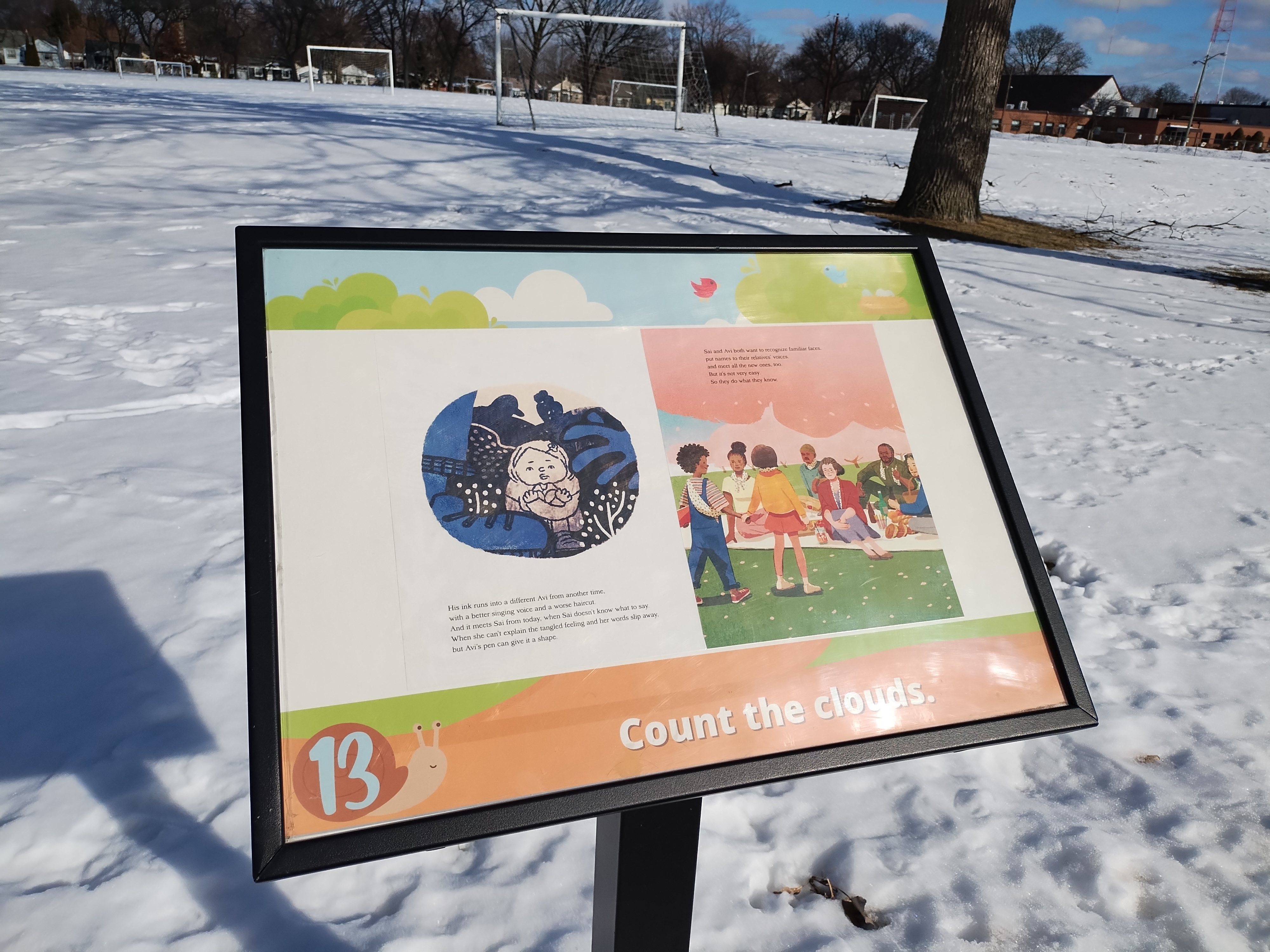 A close up of sign 13 along the Story Trail with a book page and the suggested activity "Count the clouds."